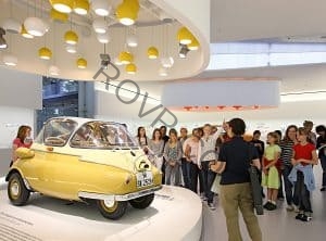 A BMW Museum Tour group views the iconic BMW Isetta