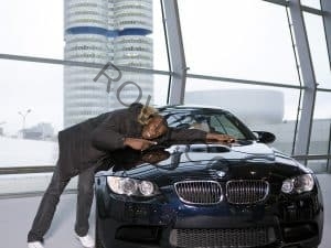 A happy customer (Usain Bolt) taking delivery of a new BMW