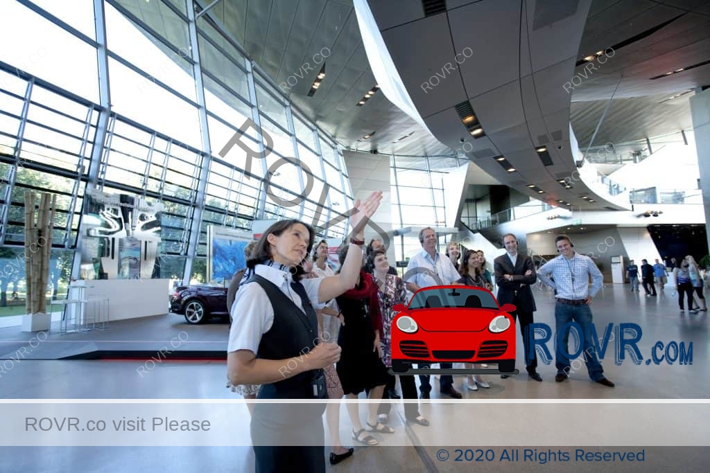 A Tour Guide with a group inside of the BMW Welt in Munich
