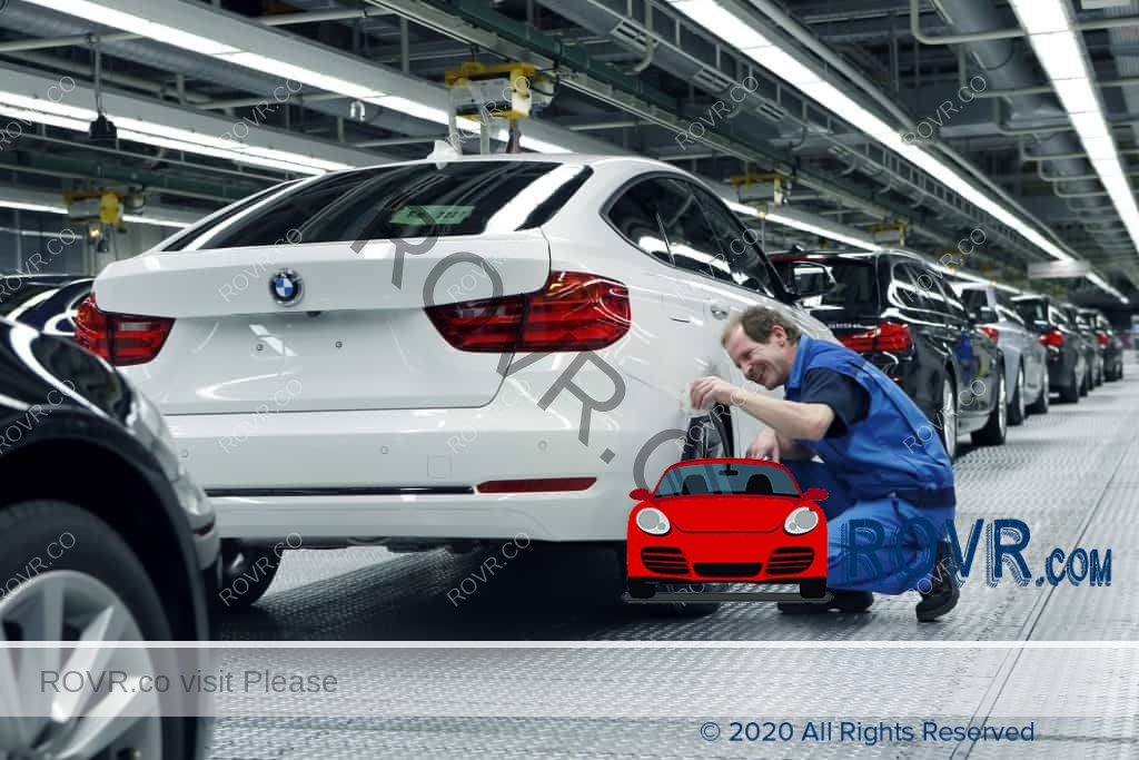 Worker performs Final checks on completed BMW
