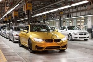 A line of completed BMW cars on the factory line