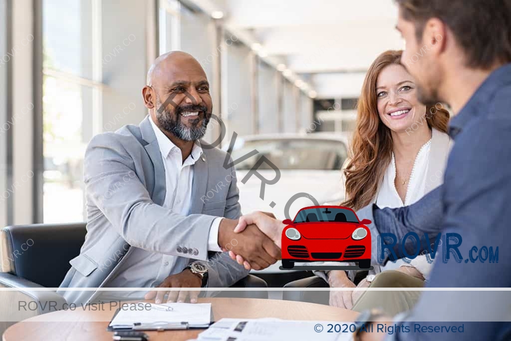 Couple meeting Salesman at car Dealership