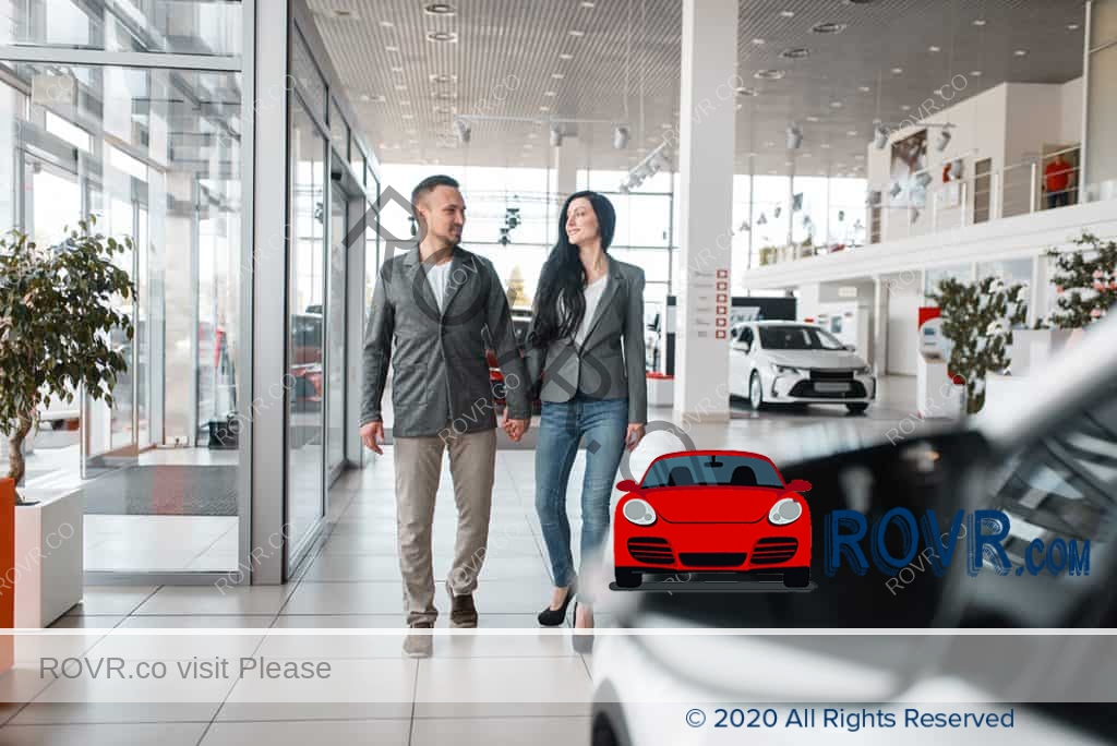 couple buying new car in showroom.